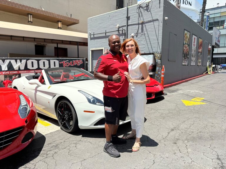 Anne and John standing in front of a white Ferrari in Hollywood Blvd