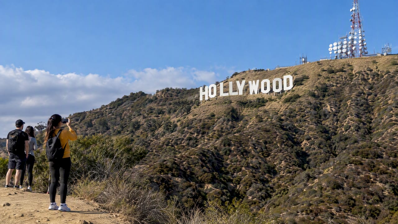 Hollywood Sign visible above clear afternoon hills